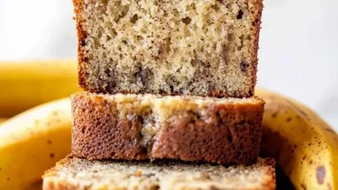 Slice of fresh banana bread on a wooden table